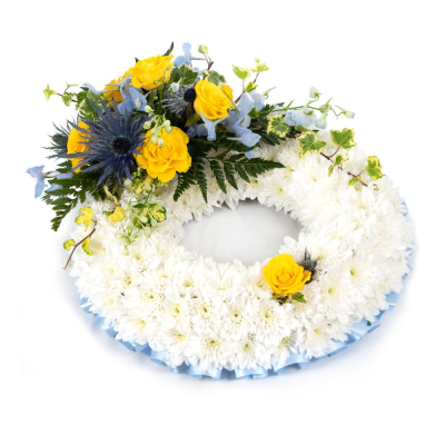 Wreath SYM-319 - This white massed wreath is finished with a blue and yellow spray for an extra special tribute. Wreath SYM-319 - This white massed wreath is finished with a blue and yellow spray for an extra special tribute.